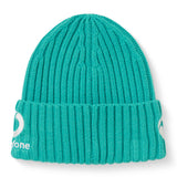 A teal ribbed knit “Ireland 26 Beanie” by Canterbury with a folded brim, featuring a white circular logo and partial text embroidered on the side.