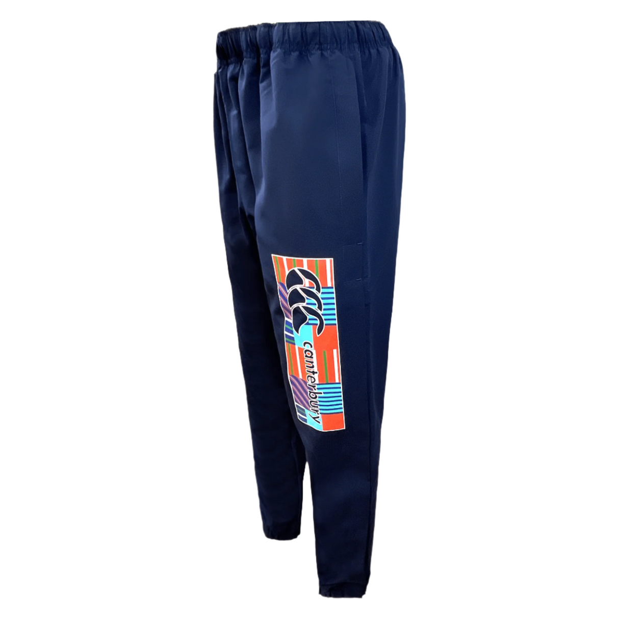 The Canterbury CCC Uglies Tapered Cuff Stadium Pant in Peacoat, featuring an elastic waistband and a vibrant graphic design on the left leg, adorned with Canterbury branding for added comfort.
