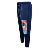 The Canterbury CCC Uglies Tapered Cuff Stadium Pant in Peacoat, featuring an elastic waistband and a vibrant graphic design on the left leg, adorned with Canterbury branding for added comfort.