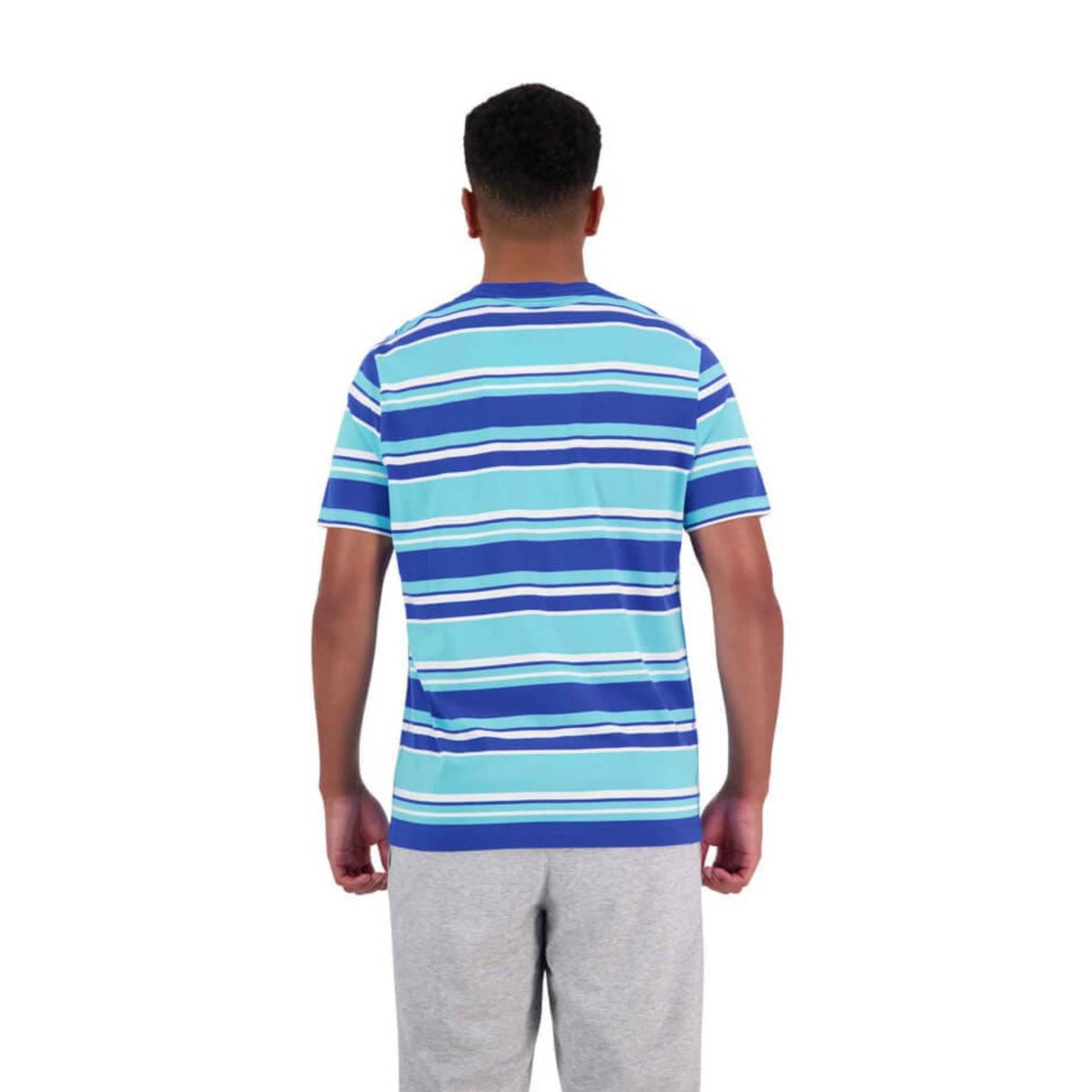 A person is shown from behind, wearing a Canterbury Yarn Dye T-Shirt by Canterbury, featuring blue and white stripes, made of 100% cotton with short sleeves and a classic crew neck, paired with light gray pants. The background is plain white.