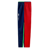 Introducing the Youth Canterbury Harlequin Stadium Trackpant 24 by Canterbury: Features one red leg, one navy leg with a white logo, and a green stripe along the sides. Perfect for making a bold statement in both style and comfort.