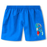 The Uglies Tactic Short by Canterbury features a bright blue color, elastic waistband, and a colorful abstract design on the lower left leg—ideal for athletic training.