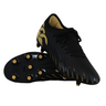 The Canterbury Phoenix 2.0 Team FG rugby boots by Canterbury, in black with gold accents and studs, are shown with one upright and one on its side—ideal as firm ground rugby boots.