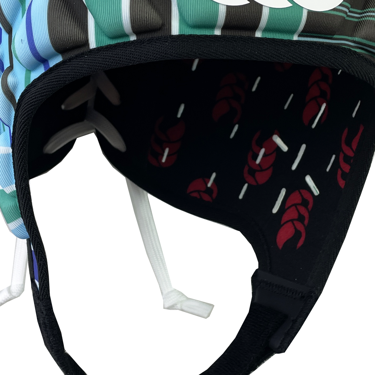 A close-up of the Raze LE Uglies Headguard by Canterbury shows a foam interior with a black pattern, red braided designs, and white stripes. Stripes also decorate Canterbury's outer shell, blending safety and style.