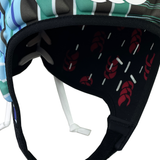 A close-up of the Raze LE Uglies Headguard by Canterbury shows a foam interior with a black pattern, red braided designs, and white stripes. Stripes also decorate Canterbury's outer shell, blending safety and style.