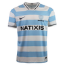 The Racing 92 25/26 Replica Home Jersey by Nike features light blue and white stripes, a black Nike logo, shield emblem, "Racing 92," and "NATIXIS" sponsor on the front—perfect for true fans.