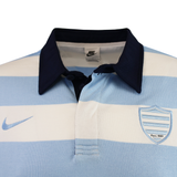The Racing 92 25/26 Heritage Long Sleeve Rugby Jersey by Nike features light blue and white stripes, a navy collar, Nike logo on the right, and a shield emblem reading "Since 1882"—a classic, tradition-inspired piece.