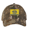 Berkeley RFC Realtree Camo Cap featuring a yellow rectangular patch with a blue bear, the text “BERKELEY RFC est. 2004”, and blue horizontal stripes.