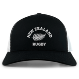 The Nations of Rugby New Zealand Retro Trucker Cap by EMB S&S Activewear features a black and white design, "New Zealand Rugby" text, silver fern logo on the front, and a classic snapback closure for adjustable fit.