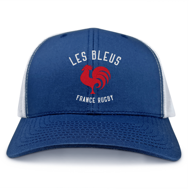 The Les Bleus France Rugby Retro Trucker Cap by EMB S&S Activewear features a blue and white design with a red rooster graphic and "LES BLEUS FRANCE RUGBY" text—ideal for fans of classic French rugby style.