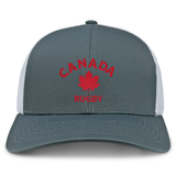 The EMB S&S Activewear Nations of Rugby Canada Rugby Retro Trucker Cap features a gray and white design with bold red "CANADA RUGBY" text, a red maple leaf emblem, and an adjustable snapback closure.