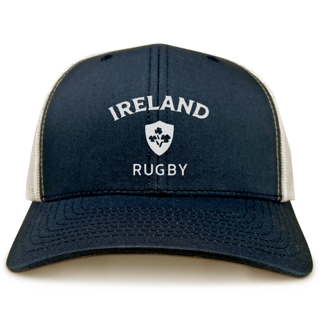 The EMB S&S Activewear Nations of Rugby Ireland Retro Trucker Cap features navy and white mesh, a printed "Ireland Rugby" logo, and a shamrock crest—ideal for any rugby fan.