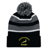 The EMB Augusta Nations of Rugby South Africa Hooped Pom-Pom Beanie features black, grey, and white stripes, a pom-pom top, "South Africa Rugby" text, and a yellow Springbok logo on the cuff—perfect for fans.