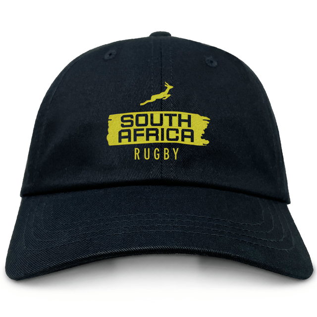 The EMB S&S Activewear Nations of Rugby South Africa Brush Stroke Dad Cap is a black dad cap with a yellow springbok and "South Africa Rugby" logo embroidered on the front—ideal for fans and collectors.