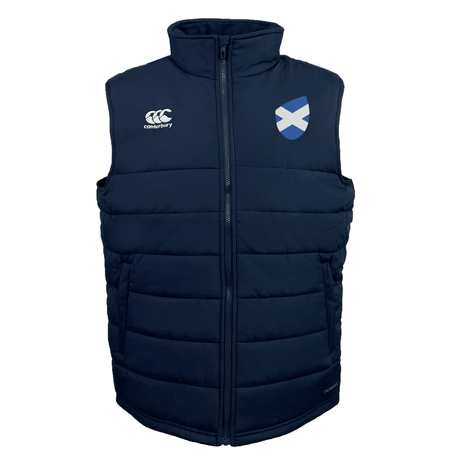The Scotland Shield Core Gilet by EMB Canterbury is a navy blue puffer vest with the Scotland rugby emblem and Canterbury logo, featuring Vaposhield for weather resistance and Thermoreg insulation to keep you warm.