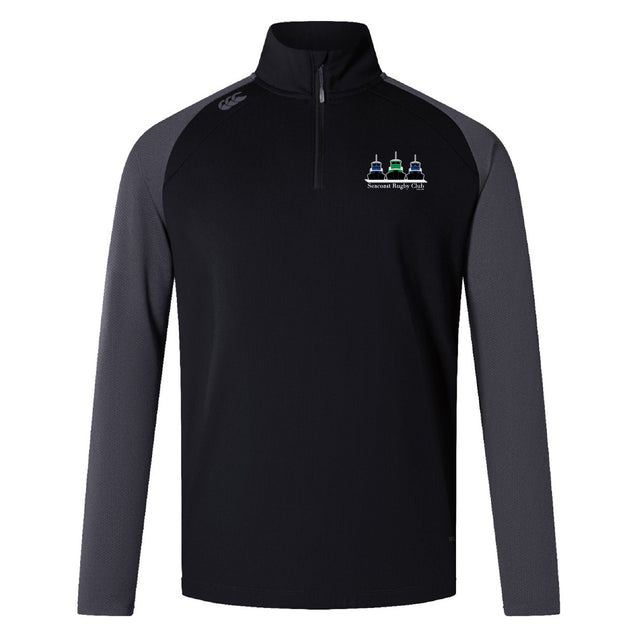 The Seacoast Rugby Club Women's Elite First Layer by EMB Canterbury is a black and dark gray long-sleeve quarter-zip pullover with a small embroidered logo, right shoulder branding, and VapoDri tech for comfort during training.