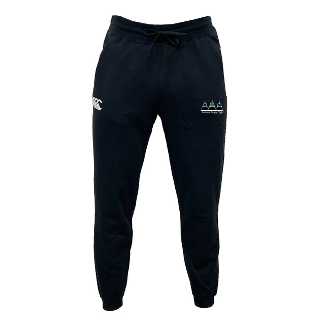 The Seacoast Rugby Club Leisure Sweatpant by EMB Canterbury is a black jogger with a drawstring waist, made from recycled polyester fleece, featuring a white logo on the left thigh and colorful embroidery on the right.