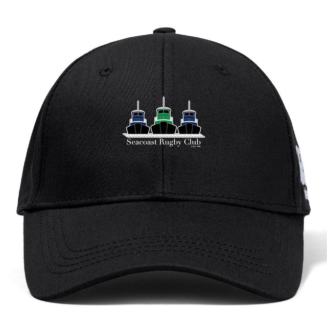The Seacoast Rugby Club Flexfit Drill Cap by EMB Canterbury features a flex fit design and an embroidered three-tugboat logo with "Seacoast Rugby Club" on the front.