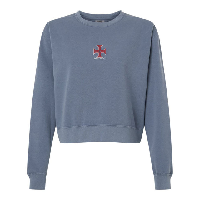 The SF CDME Rugby Women’s Garment-Dyed Mid-Length Crewneck Sweatshirt by EMB S&S Activewear features a blue, heavyweight fleece construction for a cozy feel, and showcases a small red and white cross emblem along with the text “ONE STAR” centered on the chest.