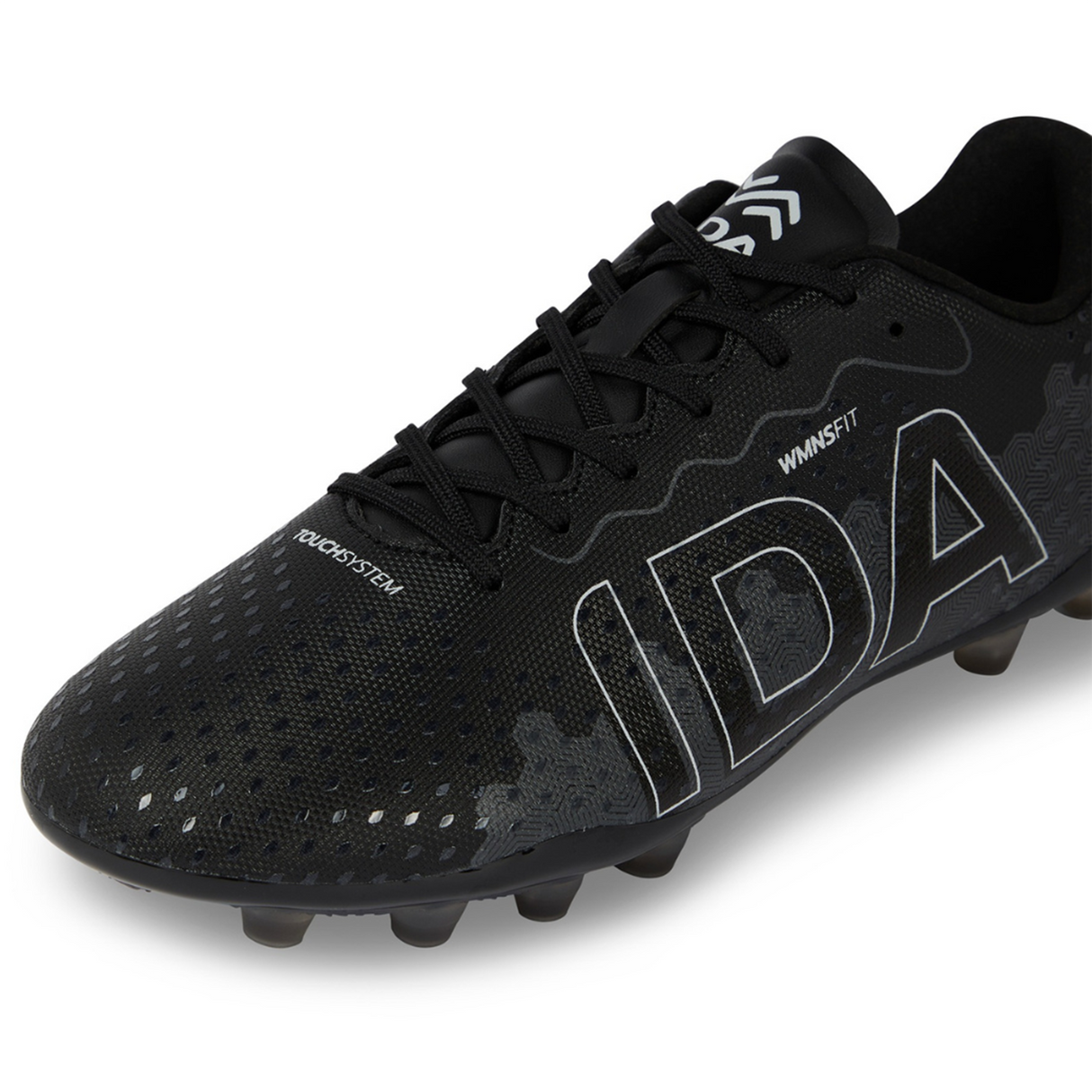 Close-up of the Ida Women's Rise Club FG "Stronger Together" cleat by IDA Sports in black, showcasing white "IDA" lettering, textured patterns, and sole studs. Made from vegan leather for an adjustable fit to enhance on-field performance.