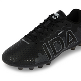 Close-up of the Ida Women's Rise Club FG "Stronger Together" cleat by IDA Sports in black, showcasing white "IDA" lettering, textured patterns, and sole studs. Made from vegan leather for an adjustable fit to enhance on-field performance.
