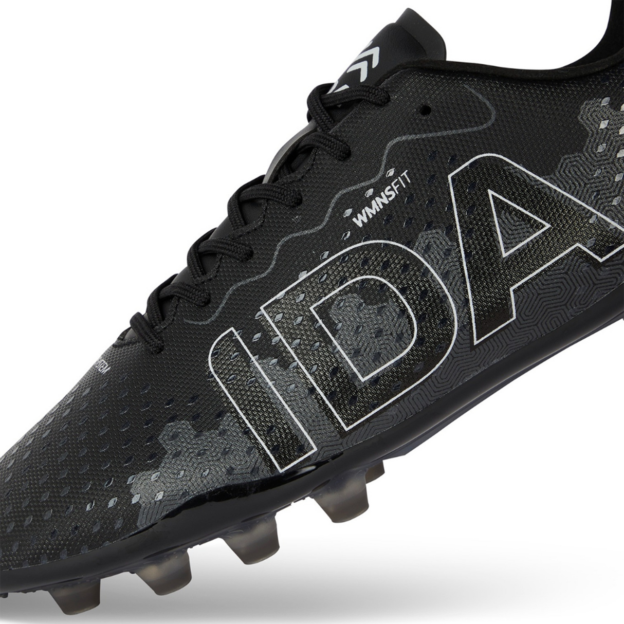 The Ida Women's Rise Club FG "Stronger Together" cleat by IDA Sports offers adjustable laces and is made from vegan leather. This black shoe with white accents and large "IDA" text on the side is designed for style and comfort, perfect for women's soccer enthusiasts.