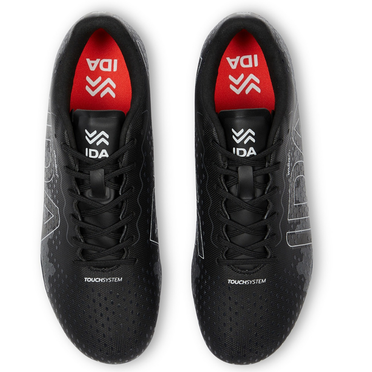 Top view of the Ida Women's Rise Club FG "Stronger Together" black sports shoes by IDA Sports, made from vegan leather with black laces, adjustable fit, and featuring a red insole with "IDA" and a stylized logo.