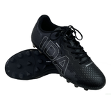 A pair of black Ida Women's Rise Club FG "Stronger Together" cleats from IDA Sports, featuring textured uppers and large silver text. Made from vegan leather, one shoe is upright while the other tilts to show its adjustable studded sole.