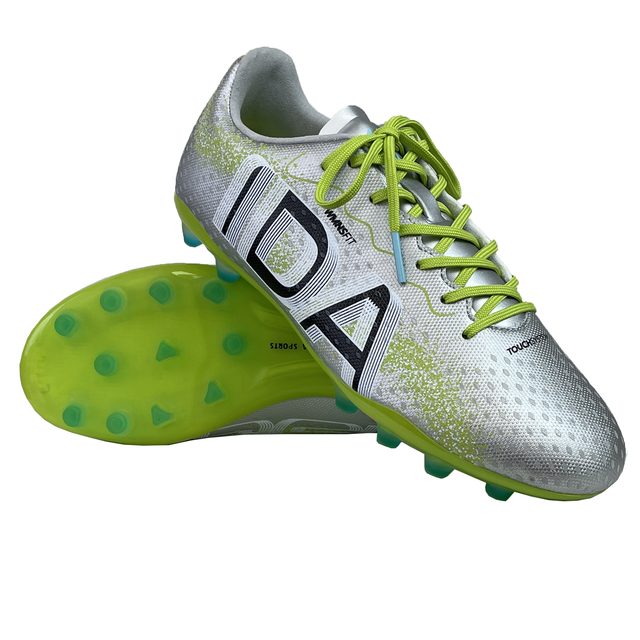 The Ida Women's Rise Club FG "Play All Day" by IDA Sports is a pair of silver vegan leather soccer cleats with neon green laces and soles, featuring black lettering for an adjustable fit.