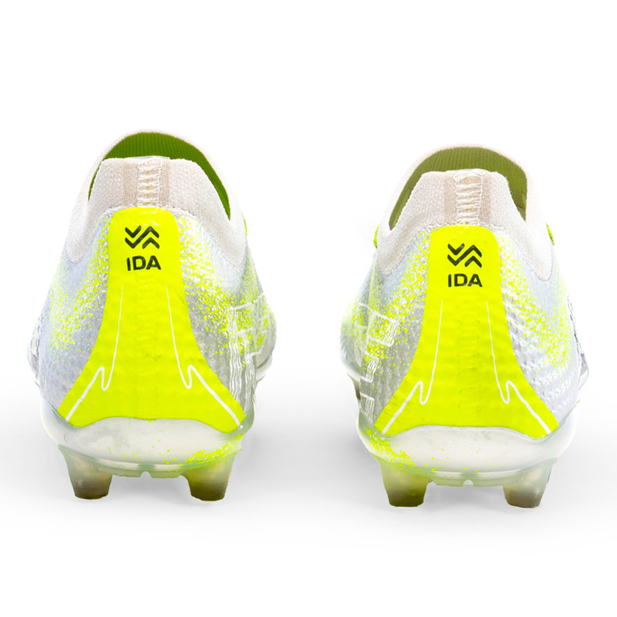 Back view of IDA Sports' Ida Women's Rise Elite FG "Play All Day" soccer cleats in silver/green, featuring "IDA" on the heel and crafted with WAVEKNIT technology for optimal performance.