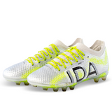 The IDA Sports Ida Women's Rise Elite FG "Play All Day" cleats in silver/green are 100% vegan, feature neon yellow laces with "IDA" on the side, and showcase crafted precision.