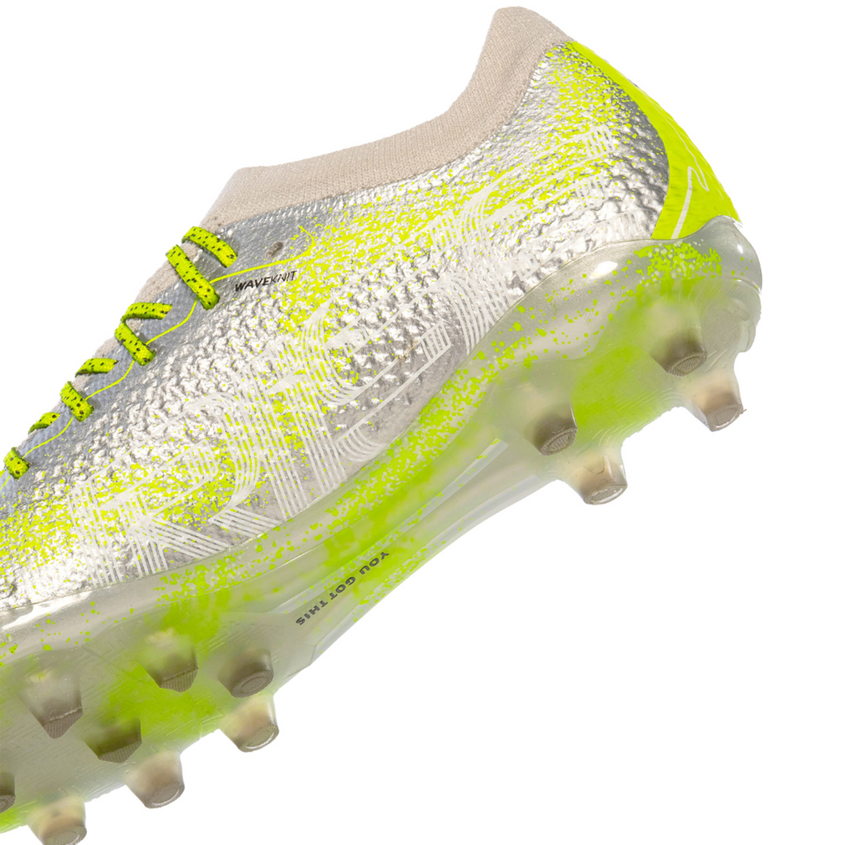 Meet the IDA Sports Ida Women's Rise Elite FG "Play All Day" soccer cleat in Silver/Green. It features a sleek design with a textured surface, translucent studs, lime green laces, and is made from 100% vegan materials for eco-friendly play on the pitch.