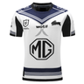 A white sports jersey with blue and black accents, this Rabbitohs NRL Heritage Jersey by Classic Sportswear features the logos of MG and Wotif alongside various other sponsor logos, proudly honoring the Royal Australian Navy.