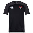 The black Superior Rugby Vapodri Evader Jersey by EMB Canterbury features a white logo, a red and white "S" team crest, and moisture-wicking fabric to keep you cool and comfortable throughout every game.