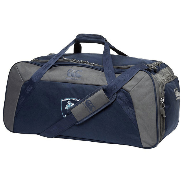 The Eckerd College Holdall Duffle Bag by EMB Canterbury features water-repellent fabric, a shoulder strap, handles, zippered compartments, and a school crest logo—ideal for carrying your rugby essentials.