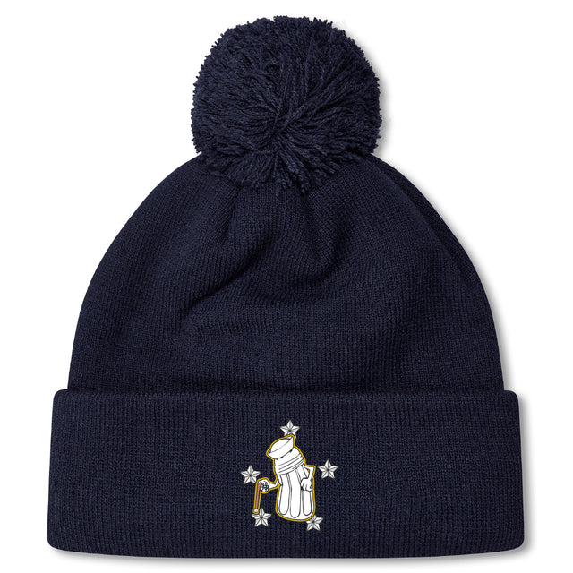 The Five Star Rugby Pom Pom Beanie by EMB Canterbury is a navy blue knit hat with a pom-pom, featuring an embroidered glove holding a candy cane surrounded by stars on the front fold.