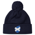 The Scotland Shield Pom Pom Beanie by EMB Canterbury, in navy blue, features a Scottish flag emblem on the front, offering warmth and national pride.