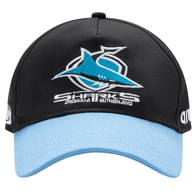 The Sharks NRL 25/26 Media Cap by Classic Sportswear is black and light blue, featuring the iconic shark logo and "Sharks Cronulla Sutherland" text. A must-have for fans, it showcases team spirit with quality craftsmanship.