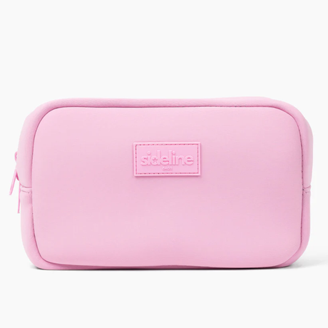 The Original Side Line Bag by SLB is a rectangular light pink waterproof neoprene zippered organizer featuring a stitched "sideline NYC" label on the front, designed for female athletes.