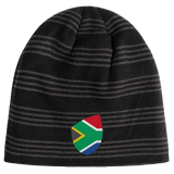 A South Africa Shield Beanie by EMB Canterbury in black with gray stripes, featuring a South African flag emblem on the front.