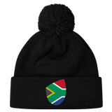 The South Africa Shield Pom Pom Beanie by EMB Canterbury is a stylish black beanie with a front cuff patch showcasing the iconic South Africa shield, combining style and pride in one cozy accessory.