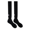 A pair of Canterbury Playing Socks by Canterbury, featuring a black knee-high design with white markings on the ankle area and a cushioned footbed for added comfort.