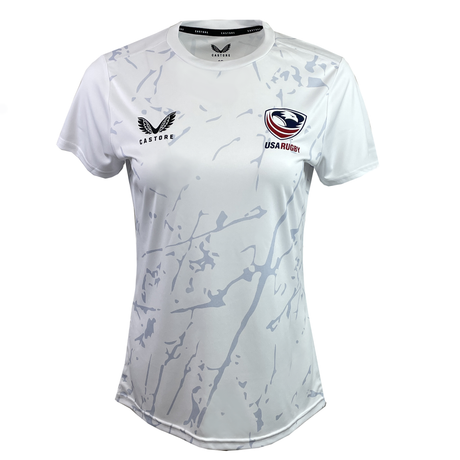 The Women's USA Rugby Training Tee by Castore in white features light gray abstract patterns, moisture-wicking tech, and displays the Castore logo with the USA Rugby crest on the chest.
