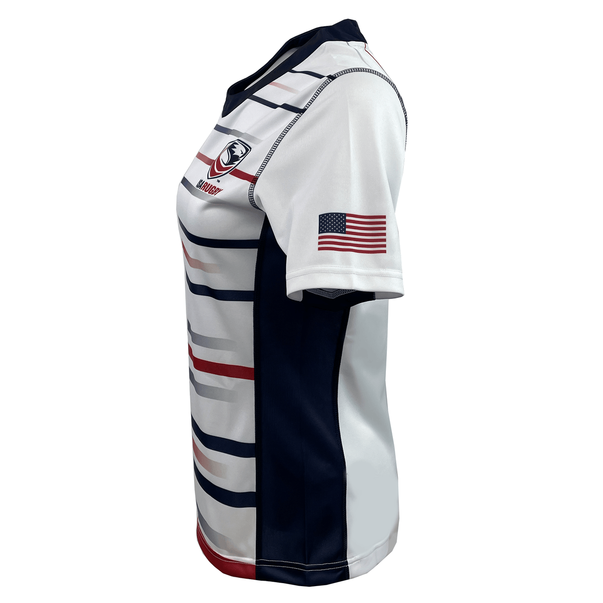 A side view of the Women's USA Rugby Pro Home Jersey by Castore highlights its athletic fit, featuring horizontal stripes and an American flag patch on the sleeve. Made from moisture-wicking fabric, it guarantees comfort and style on or off the field.