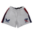 Women's USA Rugby Pro Home Shorts by Castore feature a moisture-wicking fabric, an elasticated waistband, and are adorned with the "CASTORE" logo on the left and "USA RUGBY" emblem on the right. Stylish red and blue stripes run down the sides.