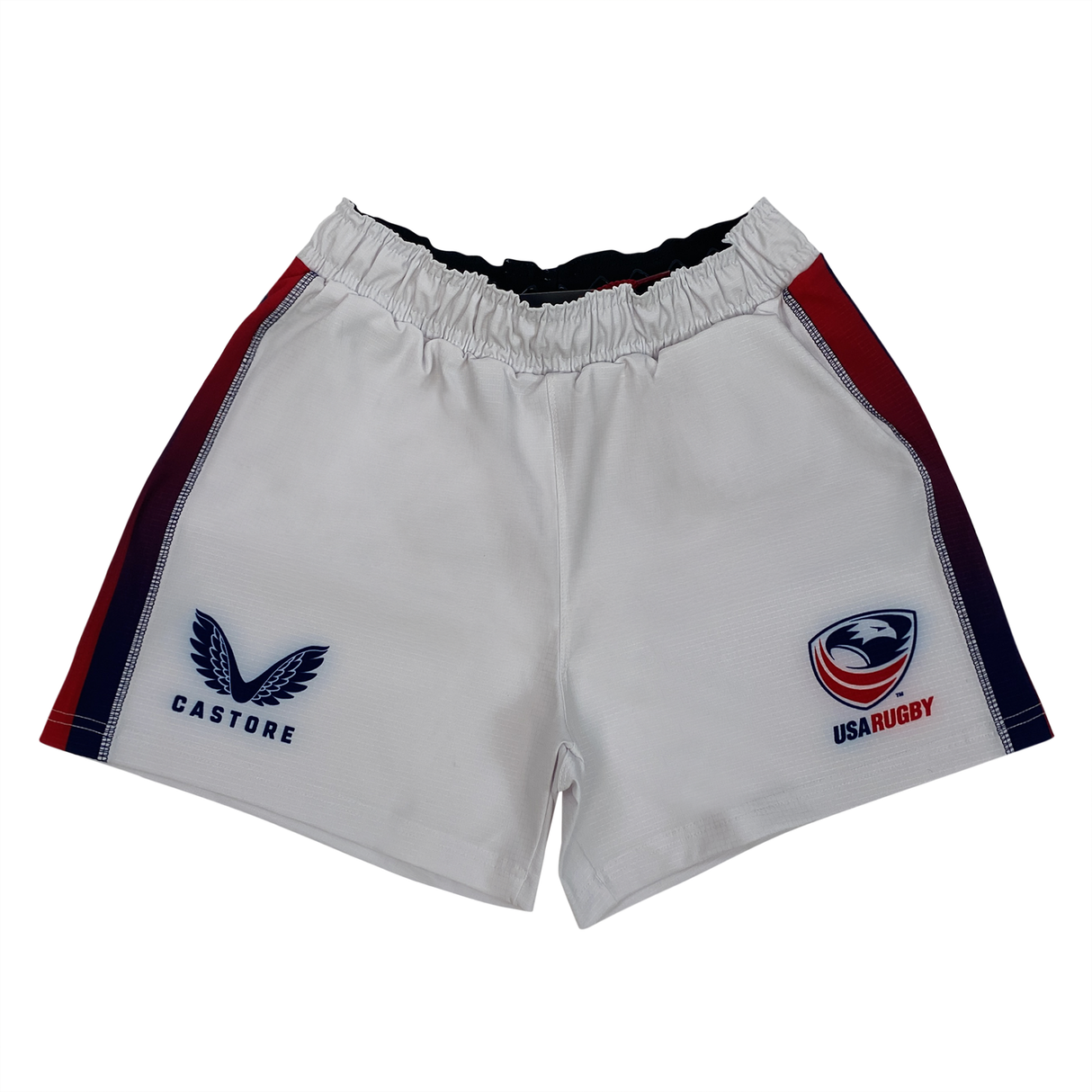 The USA Rugby Pro Home Short by Castore has a logo on the left, elasticated waistband, red and blue side accents, and is made from moisture-wicking fabric for comfort and performance on the field.