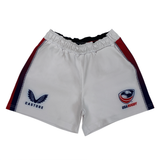 The USA Rugby Pro Home Short by Castore has a logo on the left, elasticated waistband, red and blue side accents, and is made from moisture-wicking fabric for comfort and performance on the field.