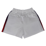 The Women's USA Rugby Pro Home Shorts by Castore boast an elastic waistband and red and blue side stripes made from moisture-wicking fabric, ideal for USA Rugby fans, shown on a plain background.