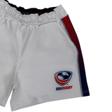 The USA Rugby Pro Home Short by Castore features an elastic waistband, the USA Rugby logo on the lower right, and bold red and blue side stripes. Made from moisture-wicking fabric, these Castore shorts offer comfort and style both on and off the field.