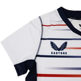 The Women's USA Rugby Replica Home Jersey 22/23 by Castore features red and blue stripes, navy trim, and the signature wings logo—ideal as a stylish women's rugby jersey or to show your USA Rugby pride.